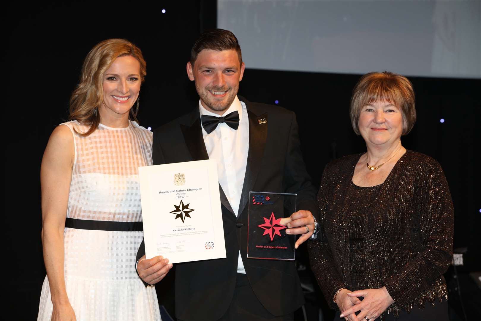 Walker Construction site supervisor Kieren McCafferty won the international safety champion award at the British Safety Council gala dinner, presented by Gabby Logan, left, and Lynda Armstrong OBE