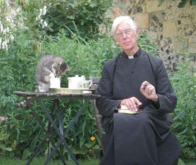Tiger the cat steals Dean of Canterbury's milk during morning prayers. Picture: Canterbury Cathedral / YouTube
