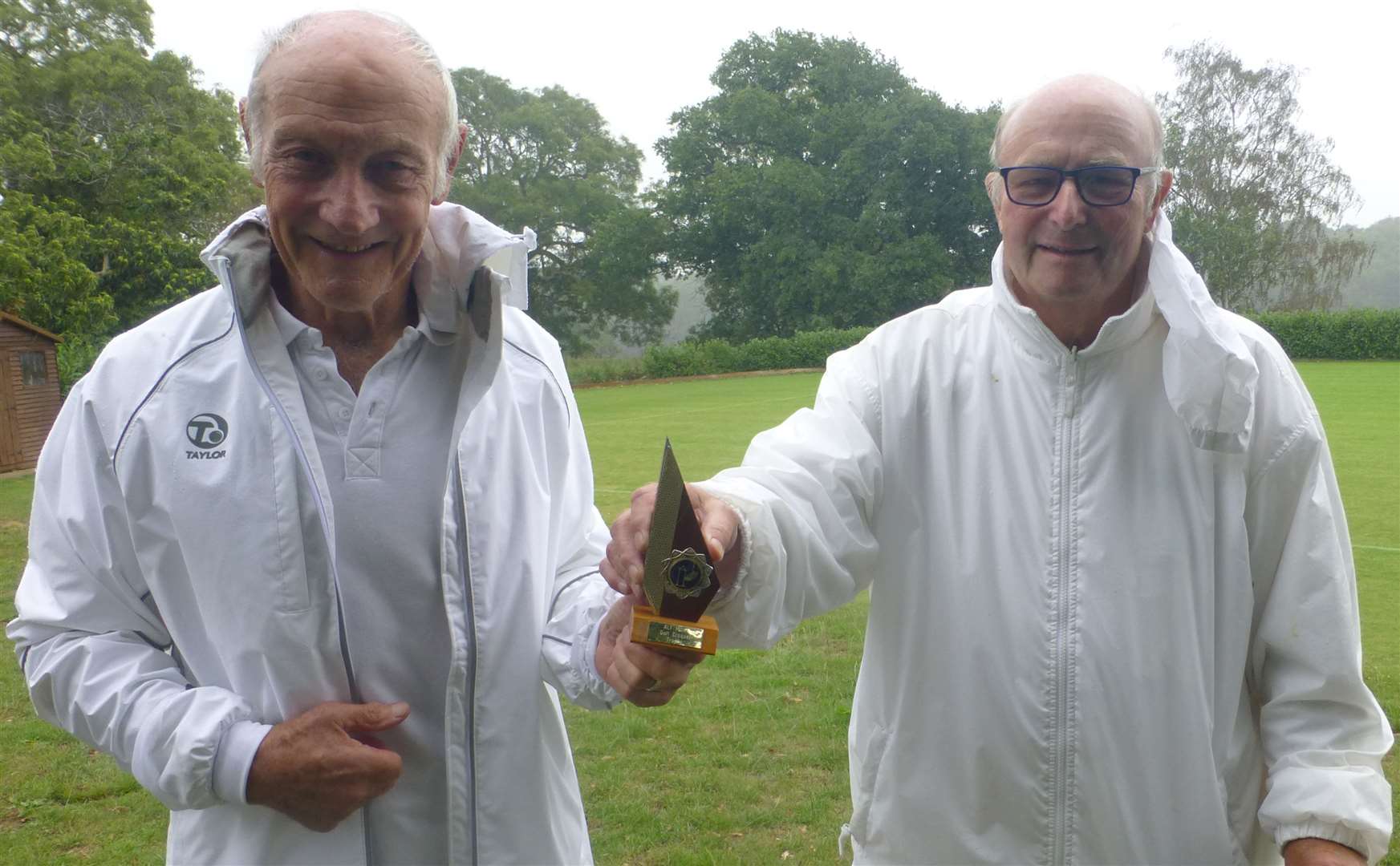 Henry Williams receives his trophy from Canterbury Croquet Club chairman Henry Bryant