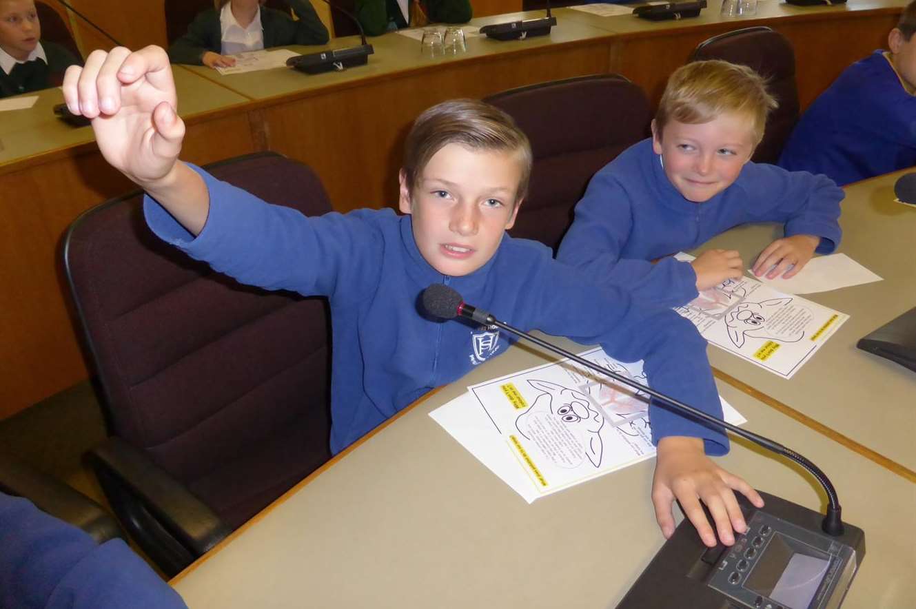 Rohan Harcup, 10, of Halfway Houses School, Sheppey, asks the Green Champion panel a question on air pollution issues, watched by Robert Pym, 10.