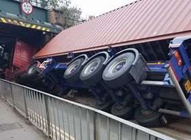 The trucks was perched on its side after the collision. Picture: Michael Taylor