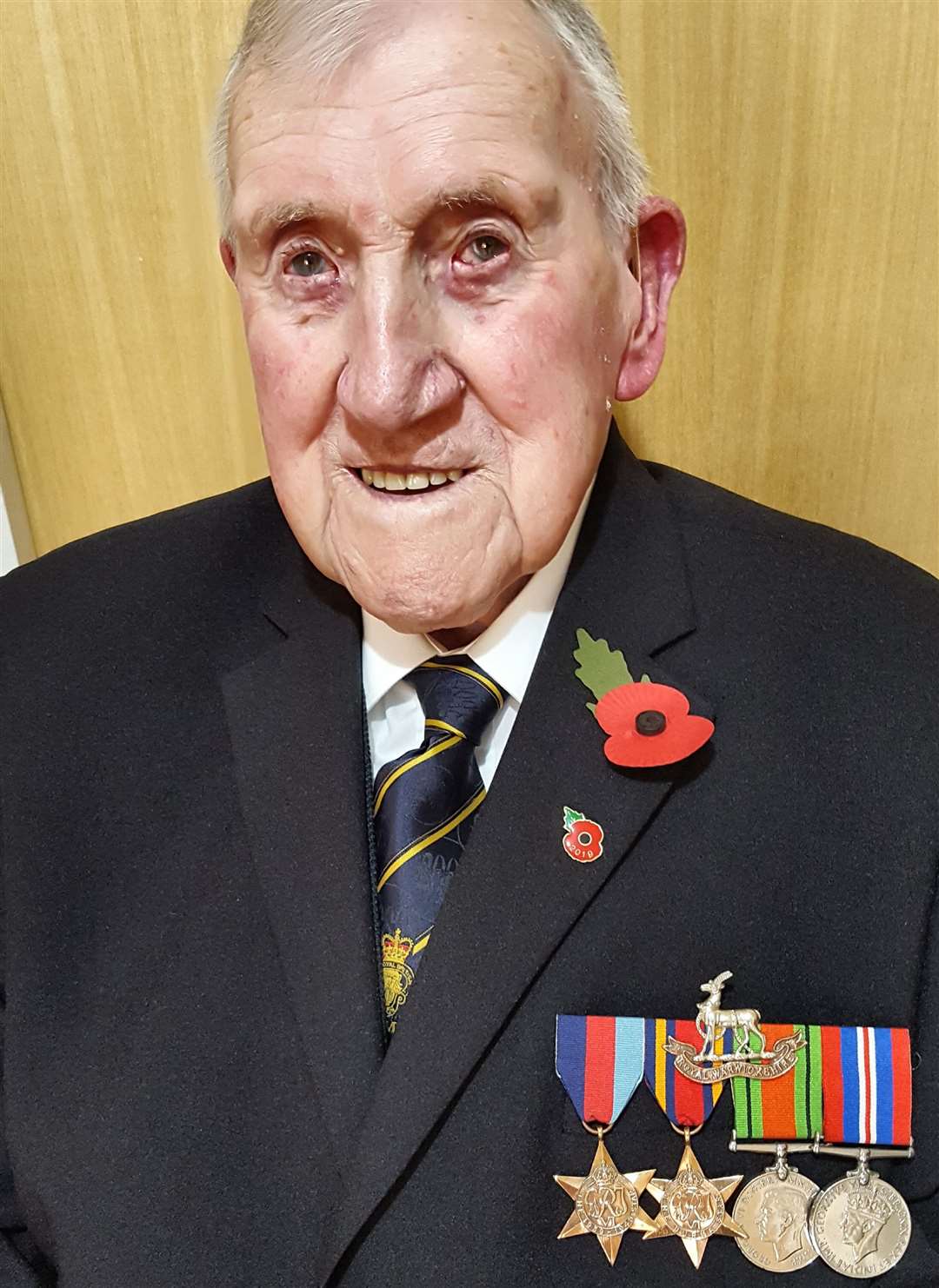 Lesie Burkett, now 99, wearing his war medals