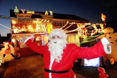 Andy Broad dressed as Father Christmas to switch on the lights outside his house in Cliffe Woods