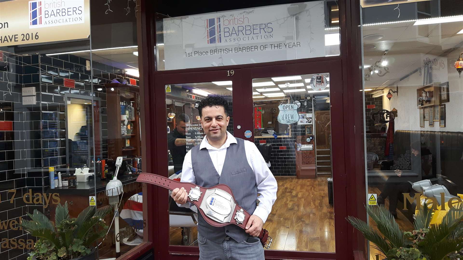 Enver 'Efe' Yeshilbulut outside his shop in Deal High Street with his third belt (7493978)
