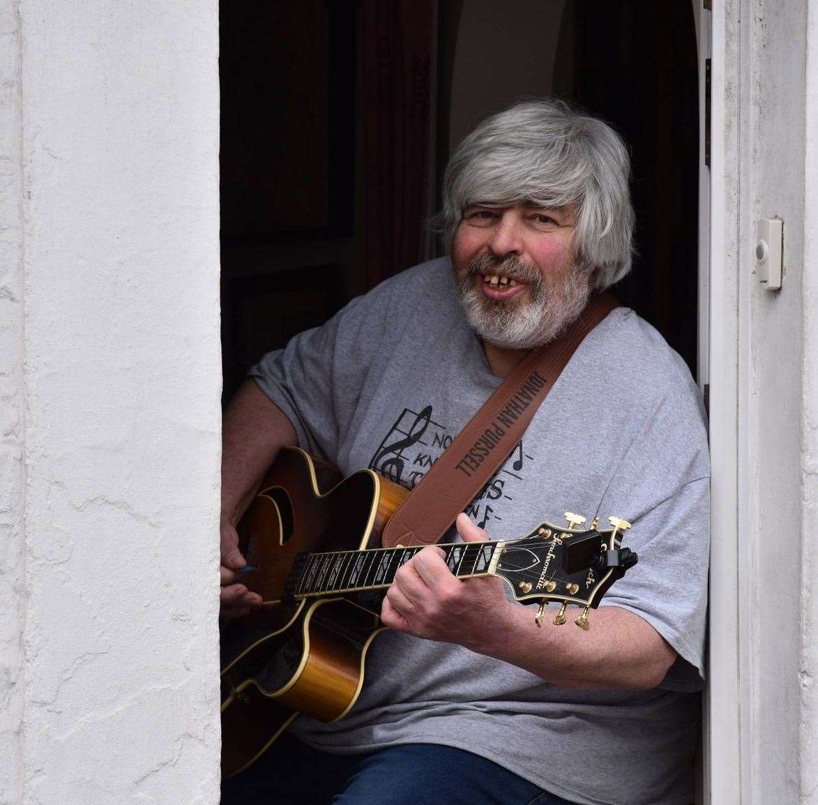 Jonathan Purssell has been playing his guitar and singing in his doorway since May 2020 Picture: Graham Keerin at Natural Images