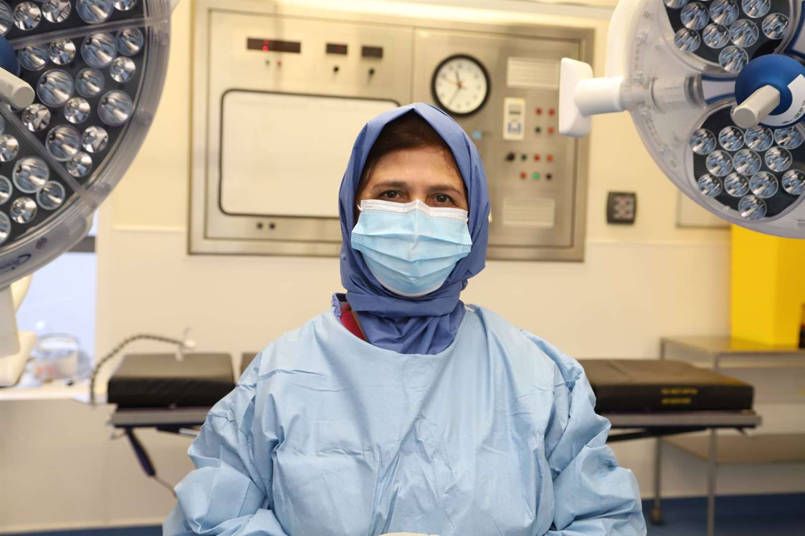 Nargis Parveen, clinical sister in theatres, wearing a new disposable head covering in theatres at Medway Maritime Hospital