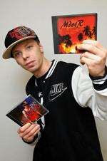 M dot R, with two of his CDs.