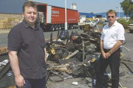 Tony Hayes and Paul Wood (in white) survey the fire damage caused by vandals. Picture: ANDY PAYTON