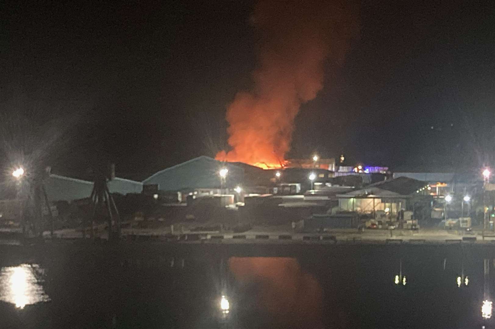 Flames can be seen pouring from the building at Chatham Docks. Picture: Duncan Mackie