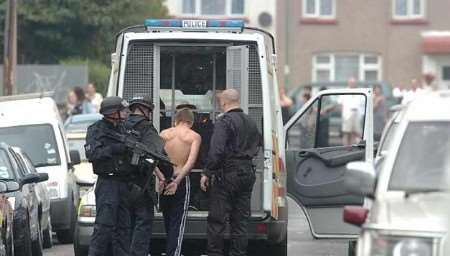 A man is placed into a police van. Picture: GRANT FALVEY