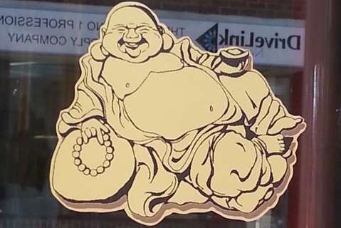 Sign on the door of the Laughing Buddha restaurant