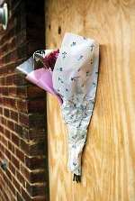 Floral tribute on the door of the flat