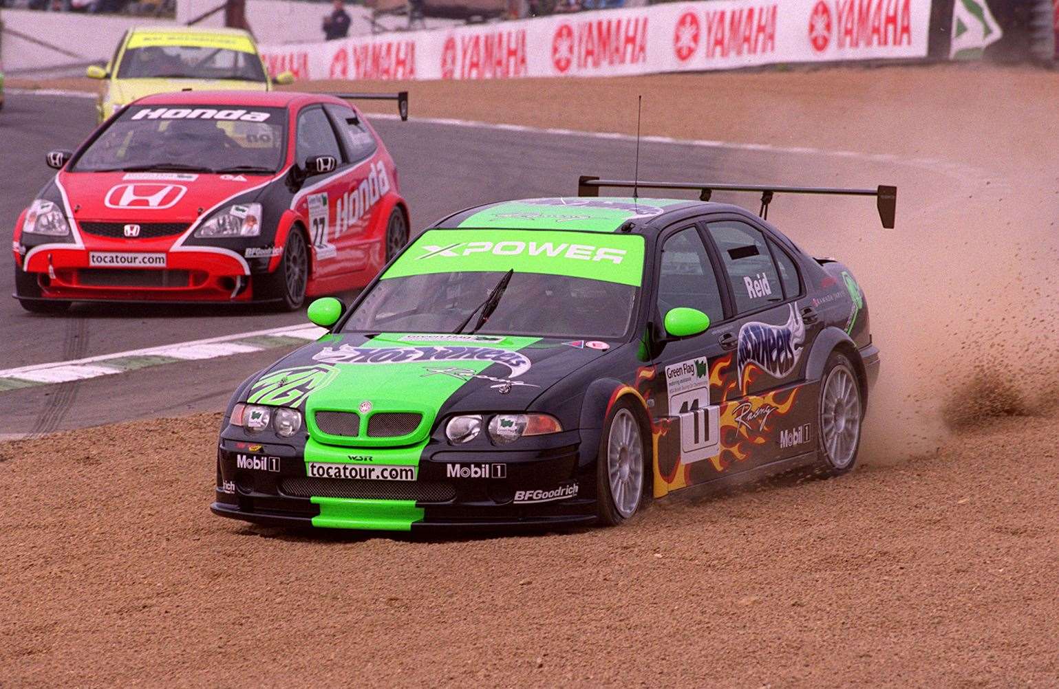 MG driver Anthony Reid is forced through the gravel at Paddock Hill Bend in a British Touring Car Championship encounter in April 2002. Picture: Andy Payton