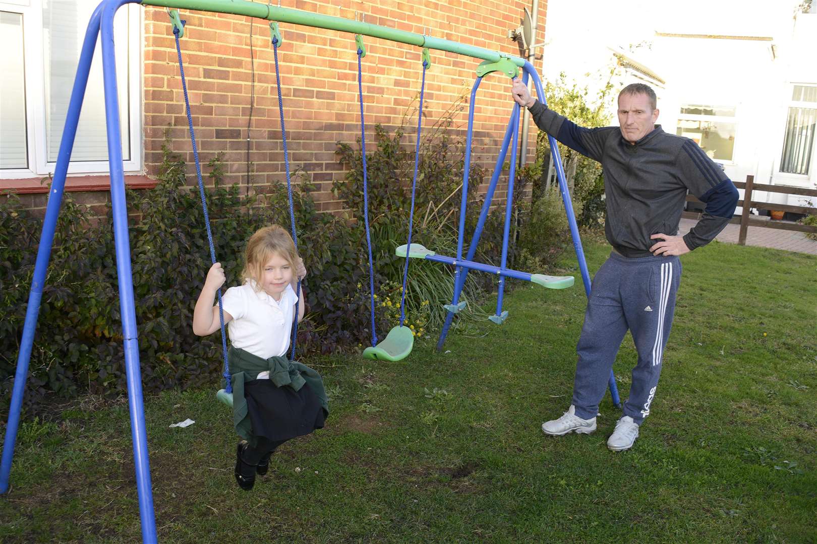 Marnie Sparks-Carter and dad Tony with the swings the council has told them to take down