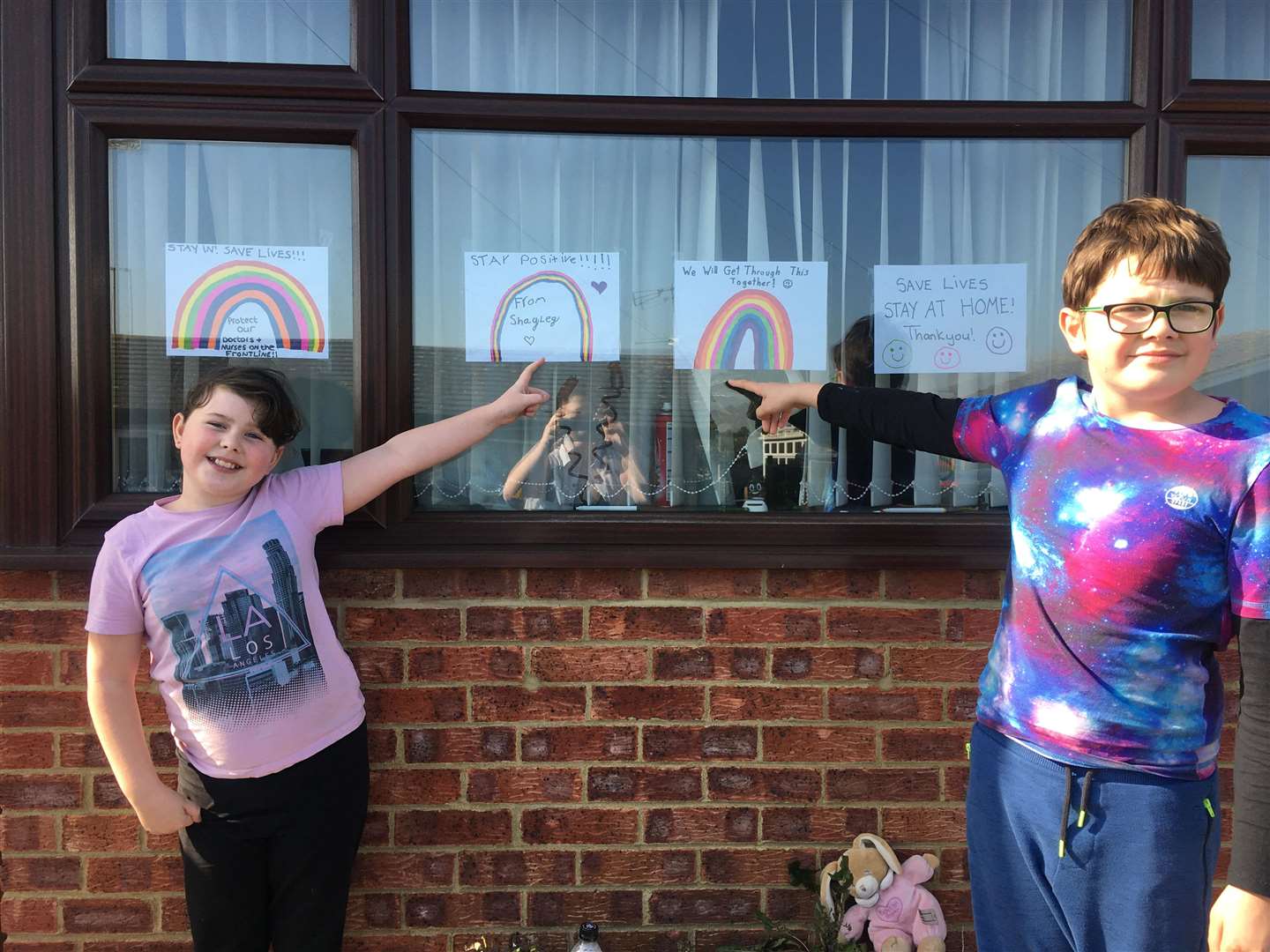 Colourful: Ellis Pearce, 12, and sister Shayley, 9, and their rainbow paintings in Minster, Sheppey