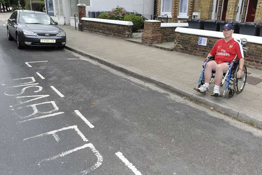 Phil next to the disabled parking space