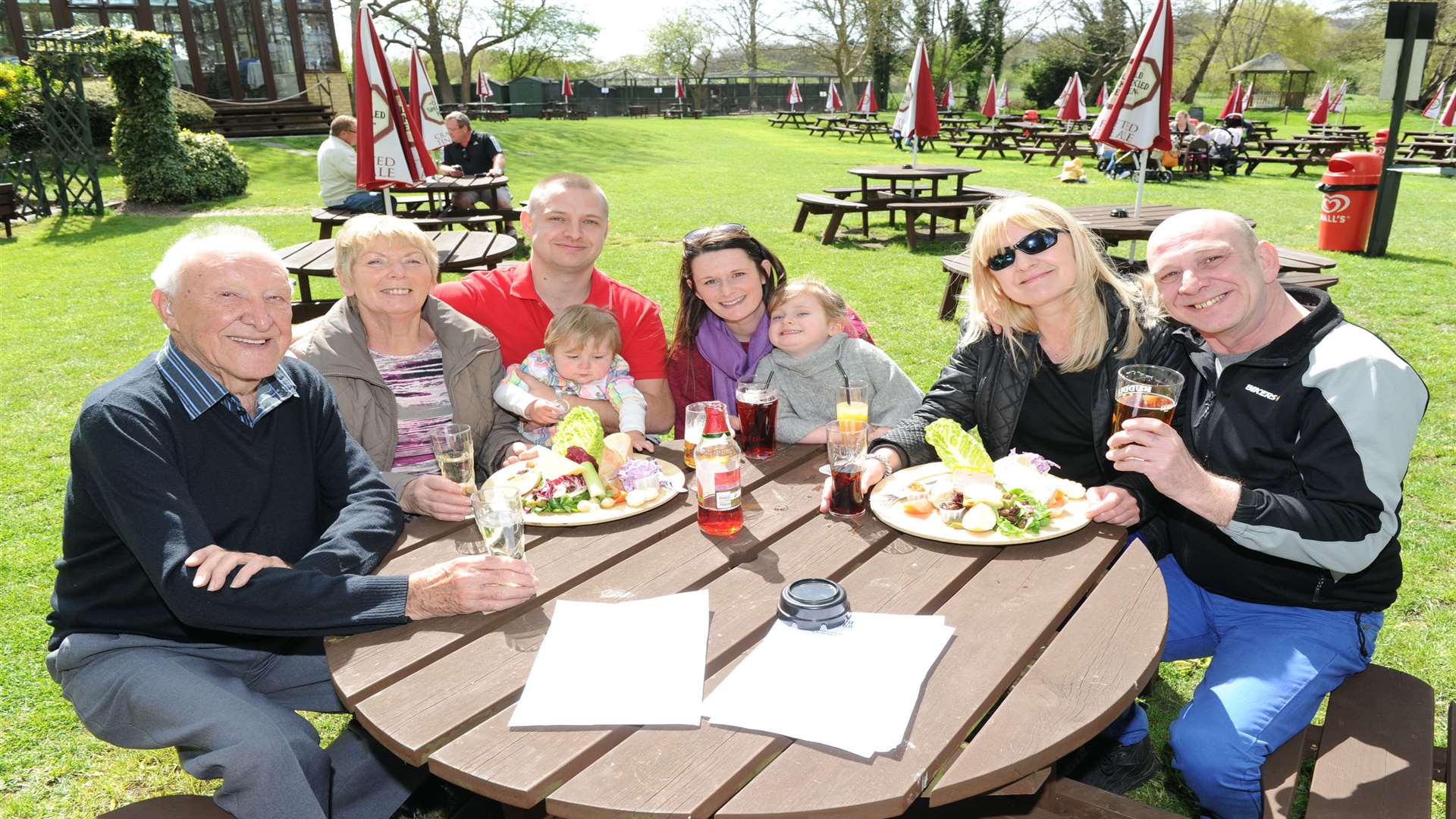 Four generations of the Langley family enjoying a meal in the garden