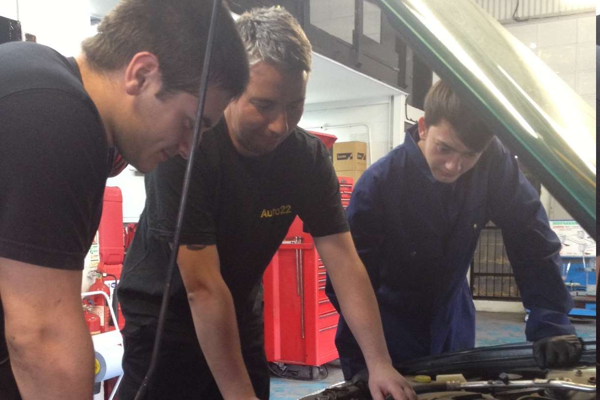 Shaun Truckell works with two apprentices