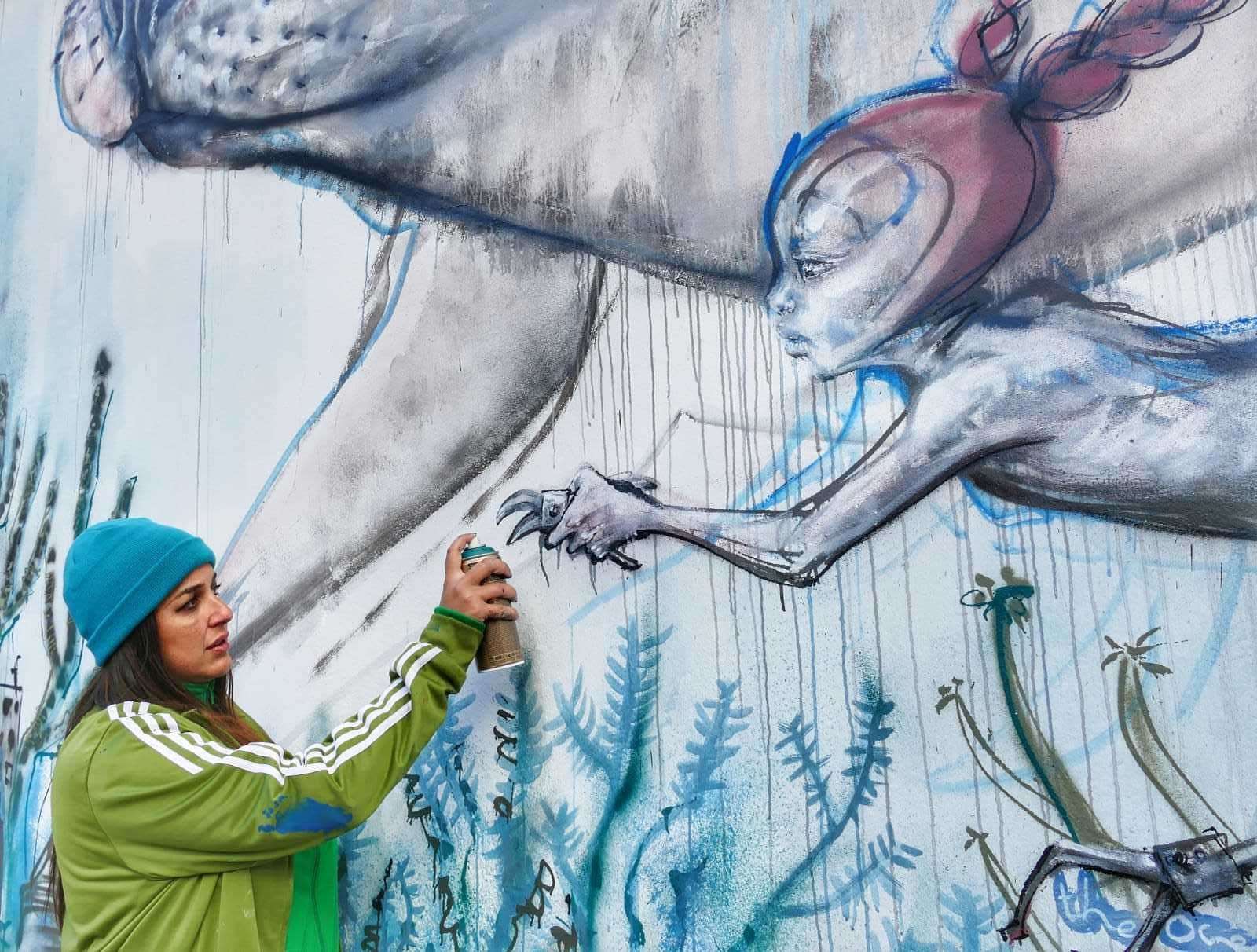 Street artist Jasmin Siddiqui (known as Hera) working on her mural in Vicarage Place. Picture: Frank Leppard