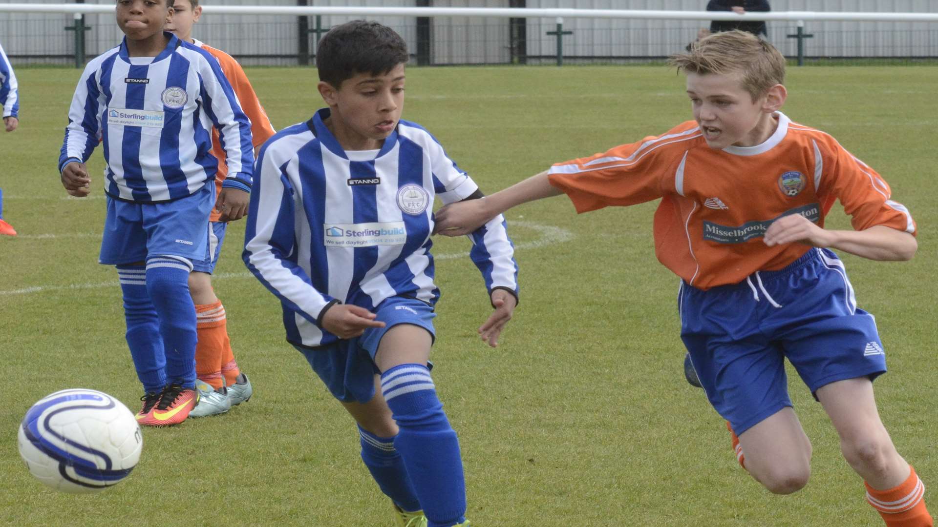 Chatham Riverside, left, and Cuxton 91 United sprint for the ball in the Under-11 Trophy final Picture: Chris Davey