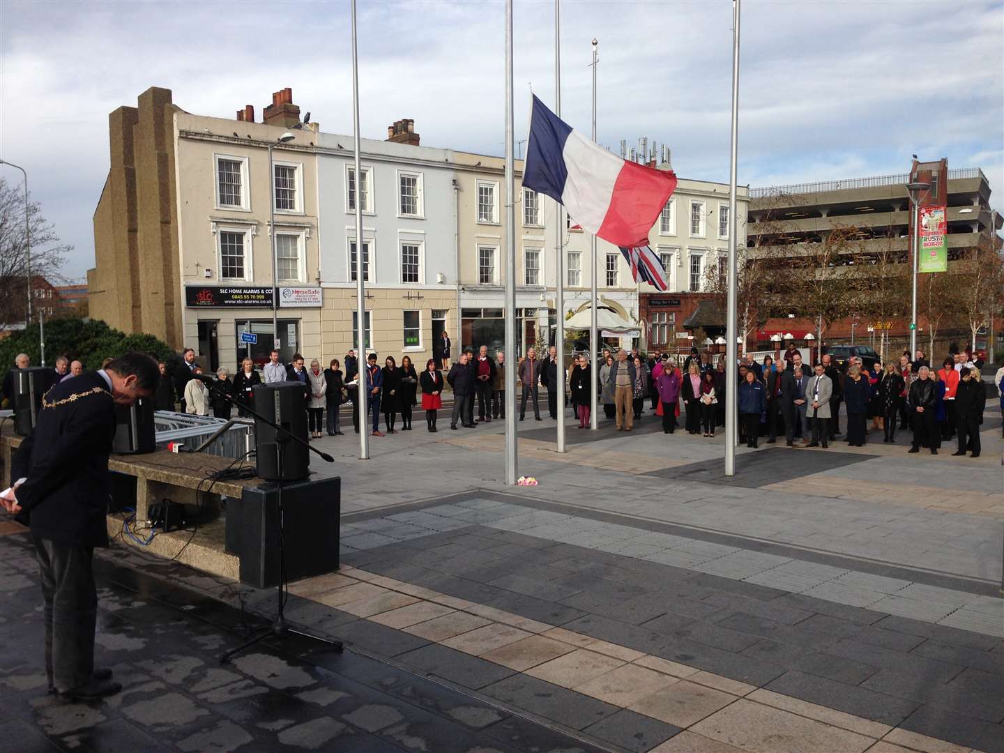 Gravesham mayor Cllr Mick Wenban bows his head during the minute's silence at Gravesend's service to those murdered during the Paris terror attacks