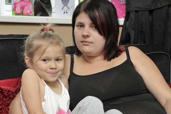 Danisha Fowler, whose leg is in plaster after a railing fell on her, with mum Kerry Hooper