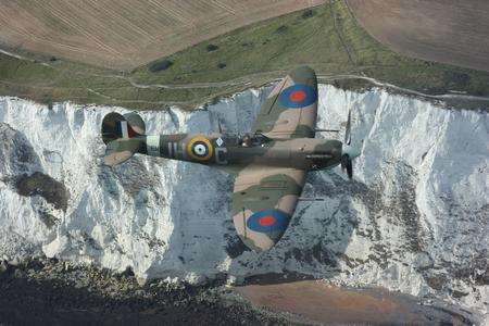 Spitfire flying against the White Cliffs