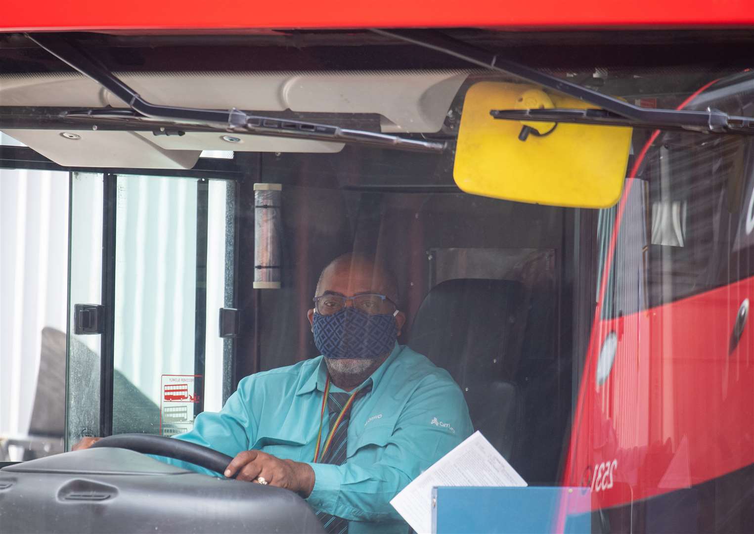 A London bus driver wearing a protective face mask (Dominic Lipinski/PA)