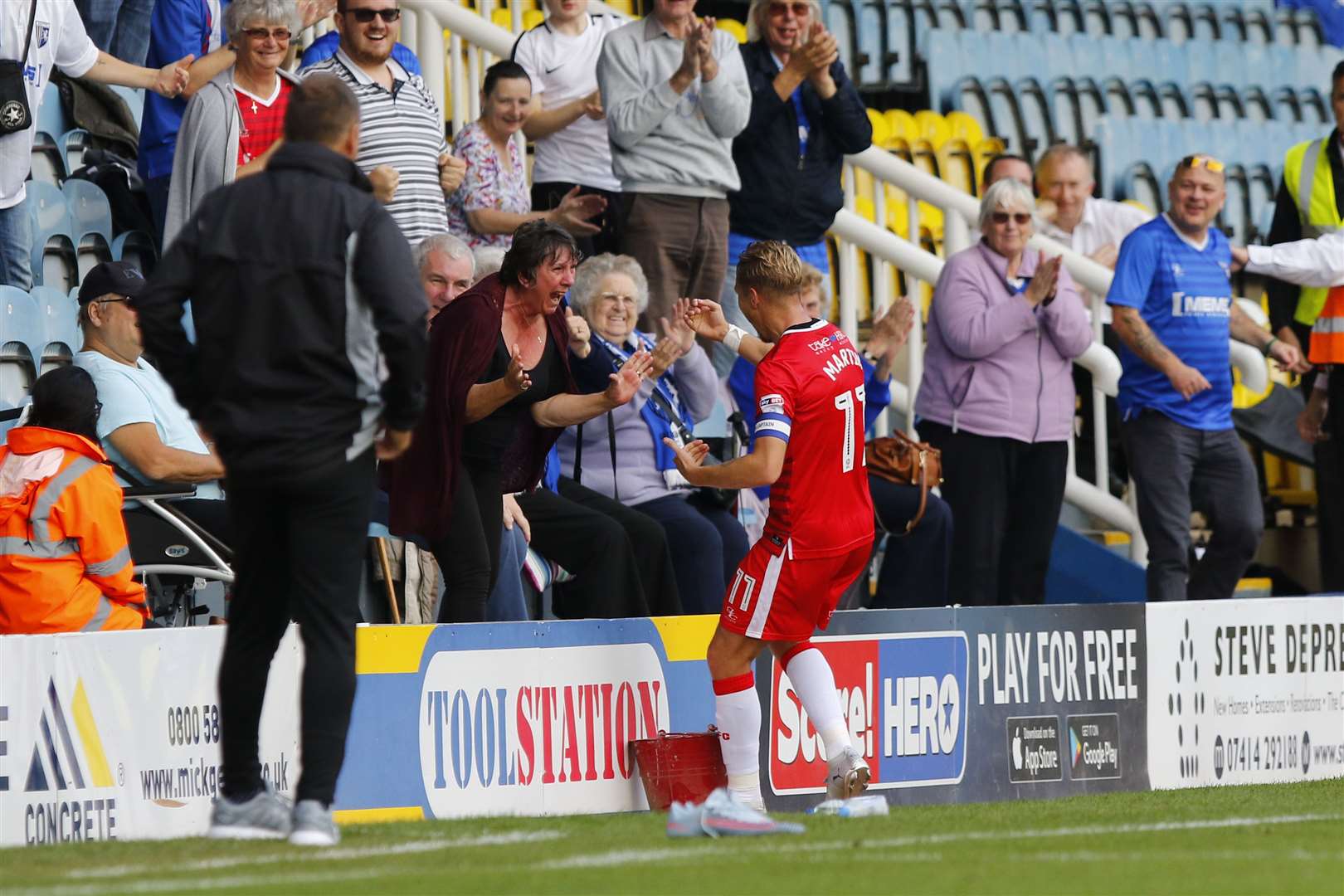 Steve Lovell looks on as Lee Martin celebrates his goal with family at Peterborough Picture: Andy Jones