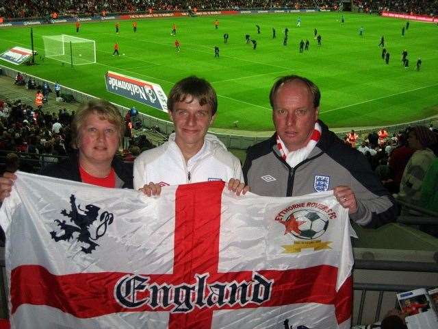 Colin Smith MBE with wife Jackie and son Daniel who have supported his endeavours. They are pictured at Wembley for a trip that he received a grant towards for under privileged children
