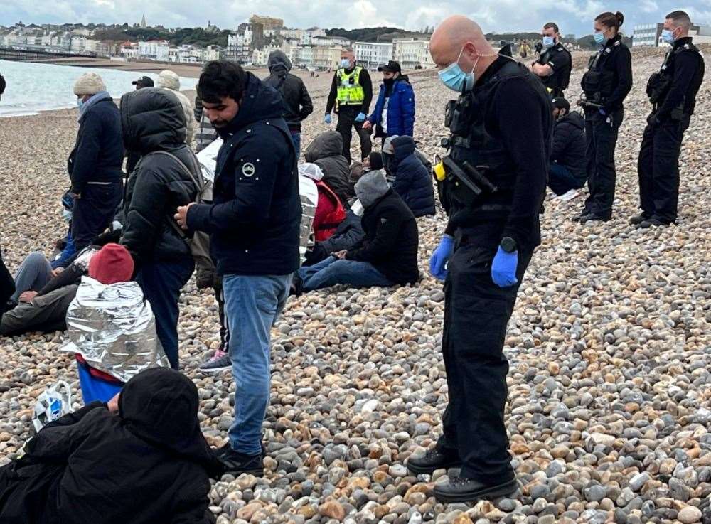 Police with suspected asylum seekers at Hastings beach. Picture: UKNIP
