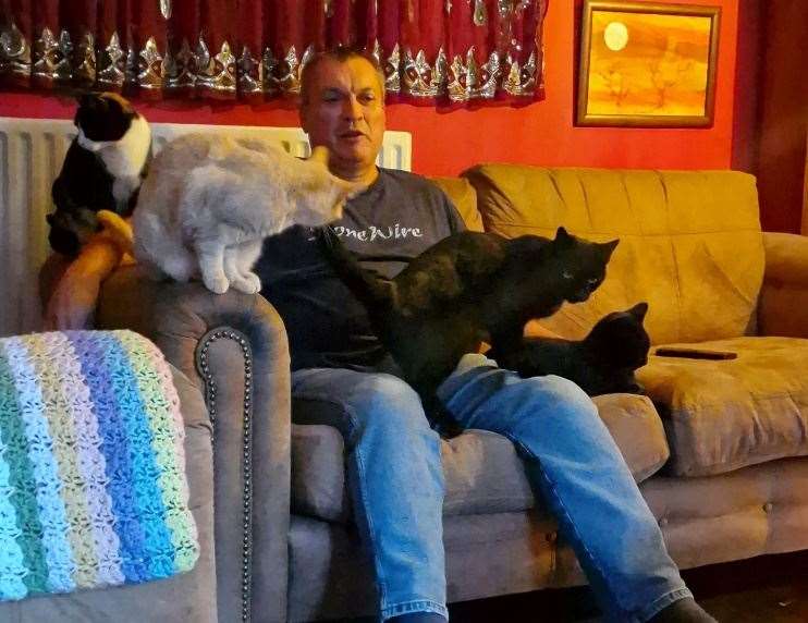 Owner Chris Wooding with his cats