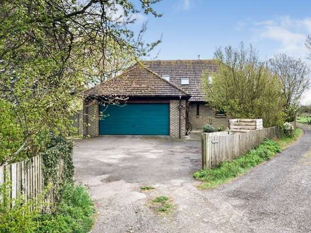 This half-a-million-pound house features a double garage at the front. Photo: Zoopla