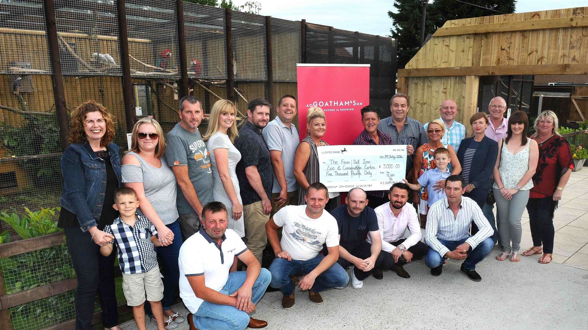 Staff from AC Goatham and Son presenting the £5,000 cheque to Fenn Bell Inn landlords Andy and Kelly Cowell