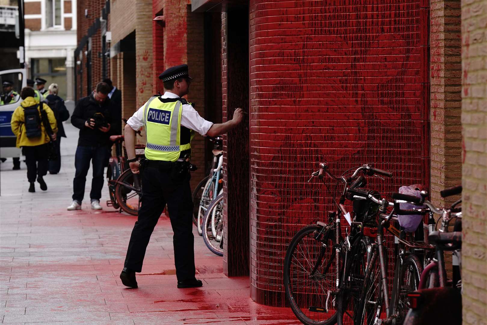 Police outside the Labour Party headquarters in London after red paint was thrown over the outside of the building (Aaron Chown/PA)