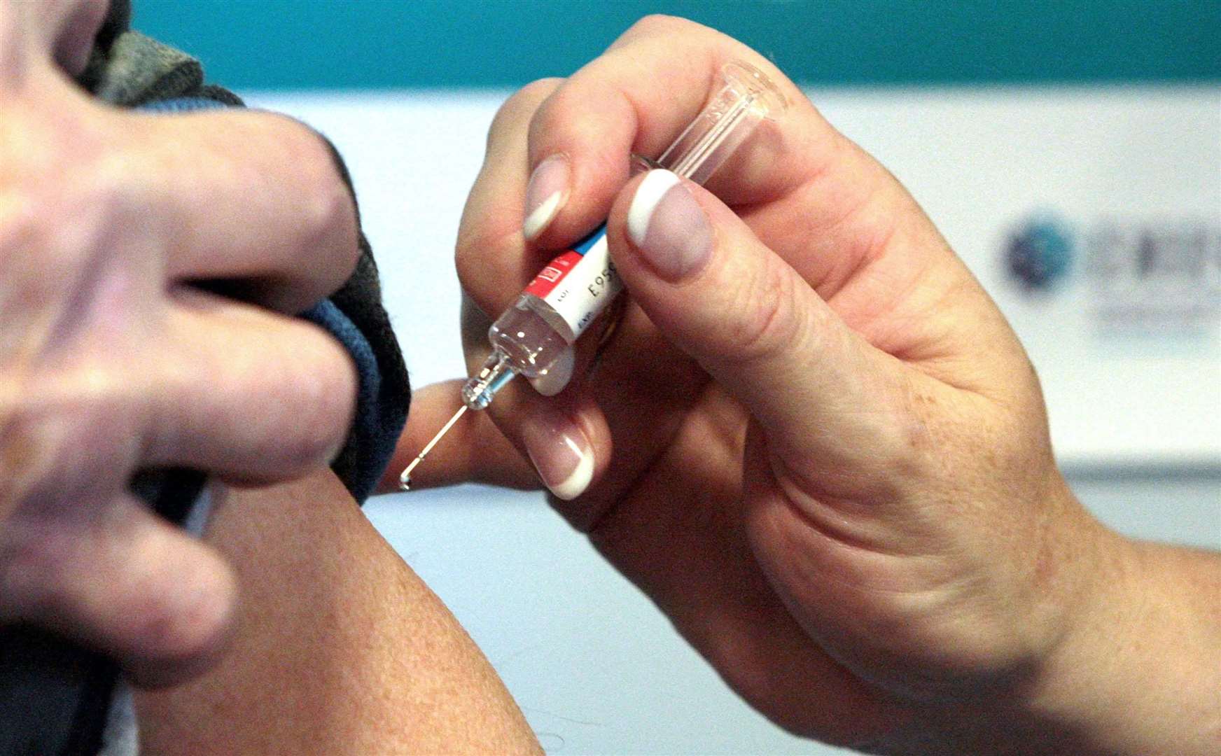 A vaccination is administered but the lack of news of the vaccine programme starting is said to be taking its toll on hospital staff. Picture: PA