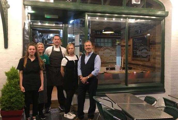 Marc and his wife Anastasiya (right), with hard-working staff, when the business opened in 2019