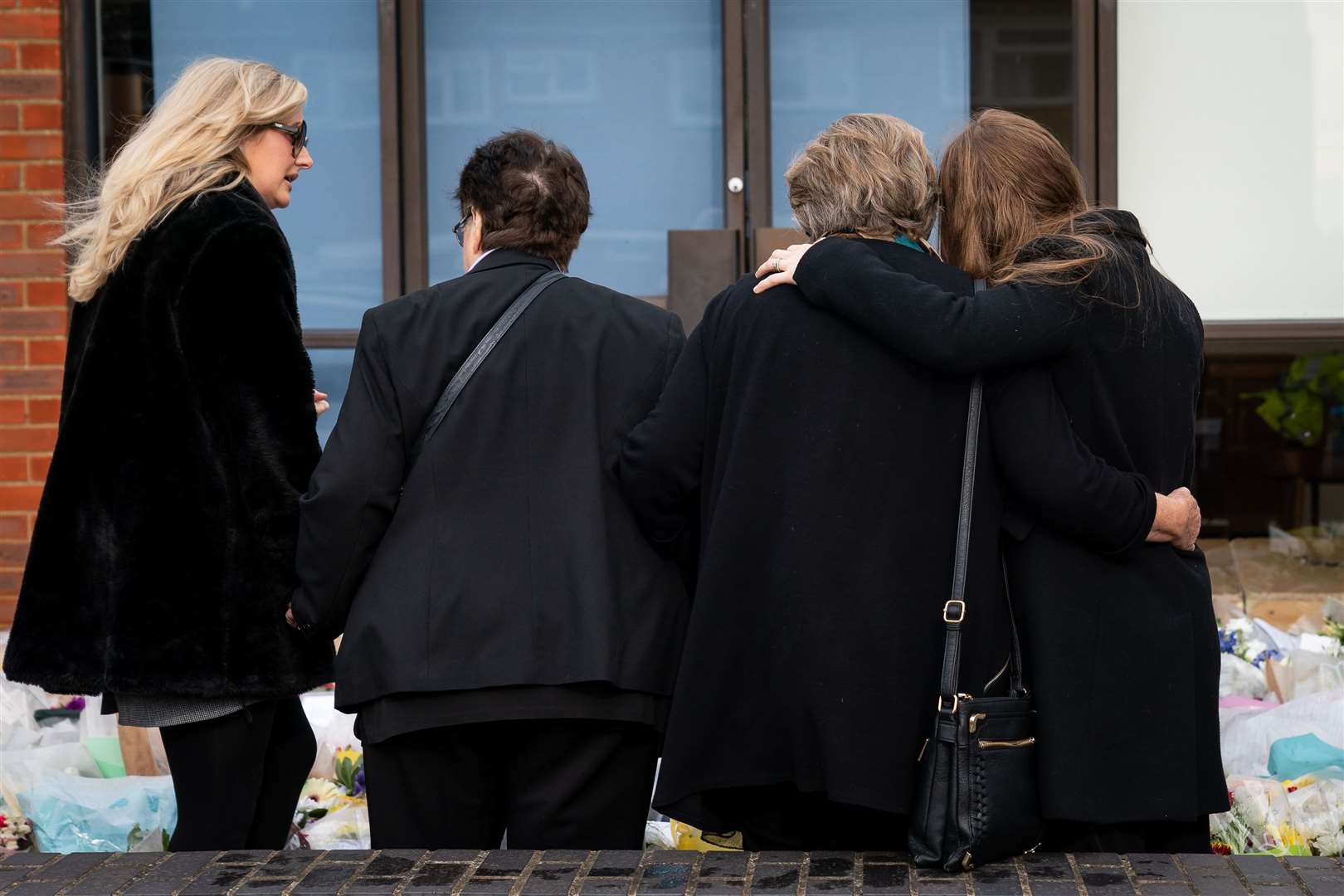 Julia Amess (second right) with family members to view flowers and tributes left for her late husband (Aaron Chown/PA)