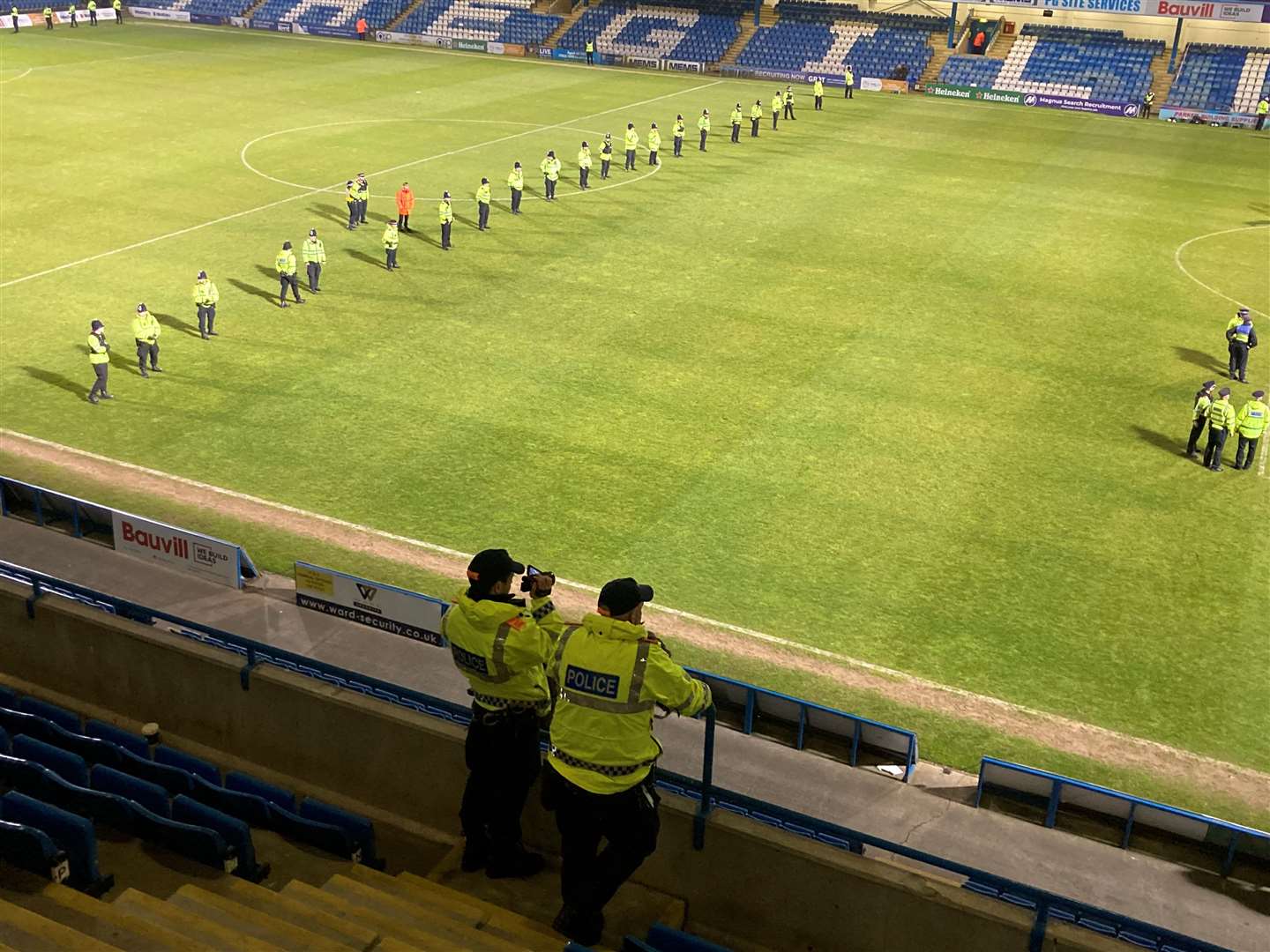Police line up on the halfway line to ensure fans are kept apart at Priestfield