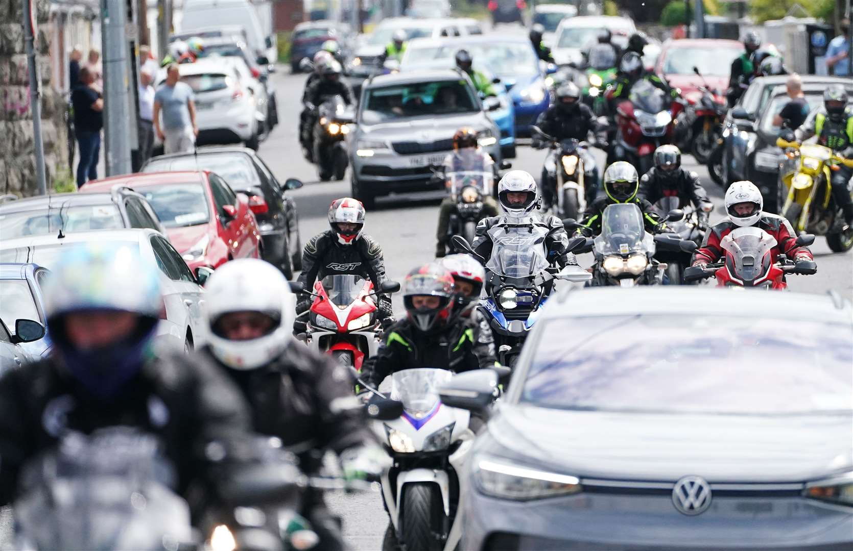 Motorcyclists follow the hearse carrying the remains of Northern Irish rider Jack Oliver as it leaves Navan (Brian Lawless/PA)