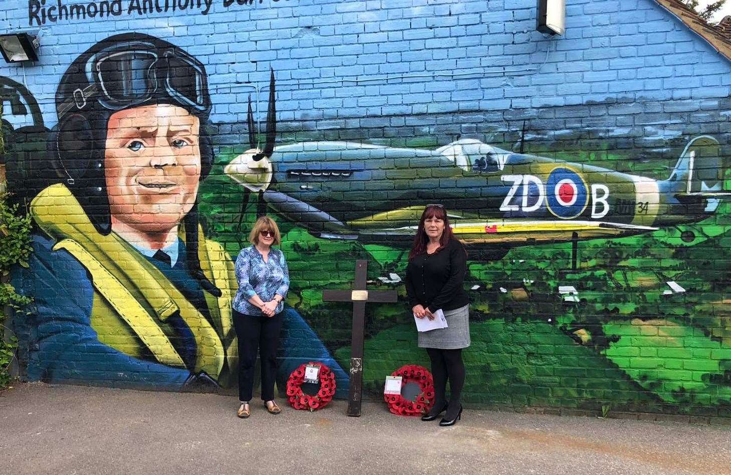 Cllr Jackie Bennett and live-in manager of The Hop Pole Inn, Rosalind Barker, in front of the mural for Richmond Anthony Barrett Blumer at the remembrance service for him on Saturday. Picture: The Hop Pole Inn