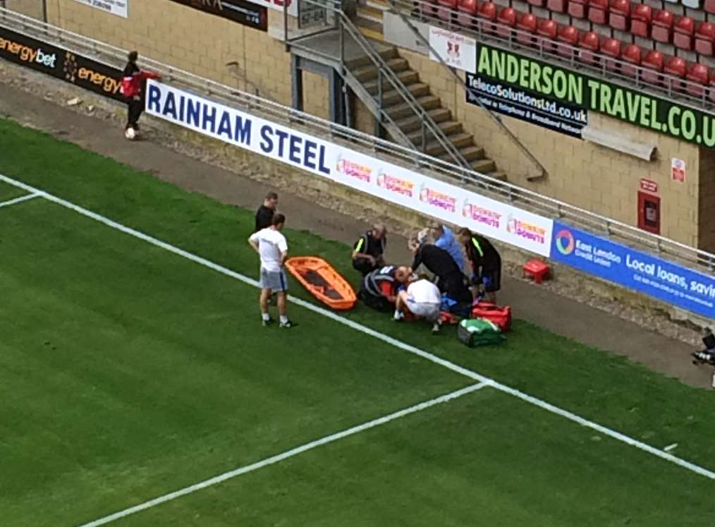 Medical staff attend Lee Martin after he goes down injured in Gillingham's game at Leyton Orient