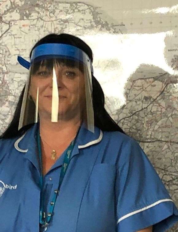 Bluebird Care worker Kerry tries out a face mask visor made by Westlands School, Sittingbourne