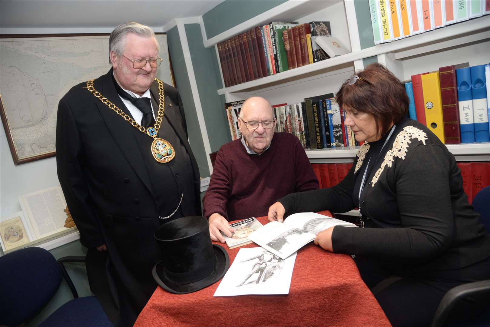 Mayor of Swale Cllr Ken Ingleton at the launch of the Charles Dickens exhibition at the Criterion Theatre in Blue Town on Thursday with trustee Mike Brown and director Jenny Hurkett in the research room. Picture: Chris Davey