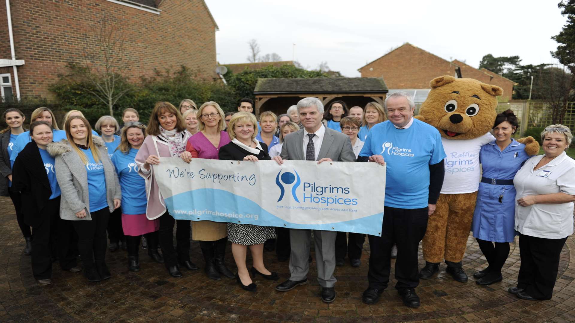 Staff and volunteers from the Pilgrims Hospice celebrate becoming our charity of the year with chief reporter Gerry Warren at their base in London Road, Canterbury