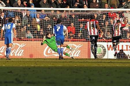 Charlie MacDonald rifles home his and Brentford's second penalty. Picture: Barry Goodwin
