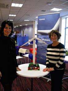 Sara Alwan, Vestas communications specialist, presents Mari Russell with her prize - a Lego wind turbine model