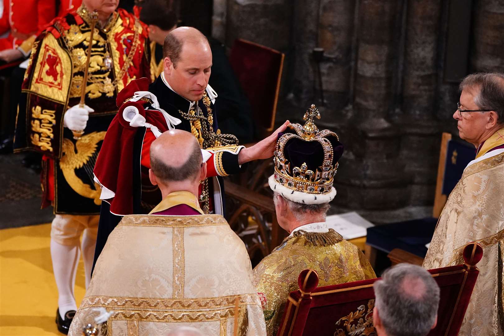 The Prince of Wales touches St Edward’s Crown on Charles’s head during the coronation (Yui Mok/PA)