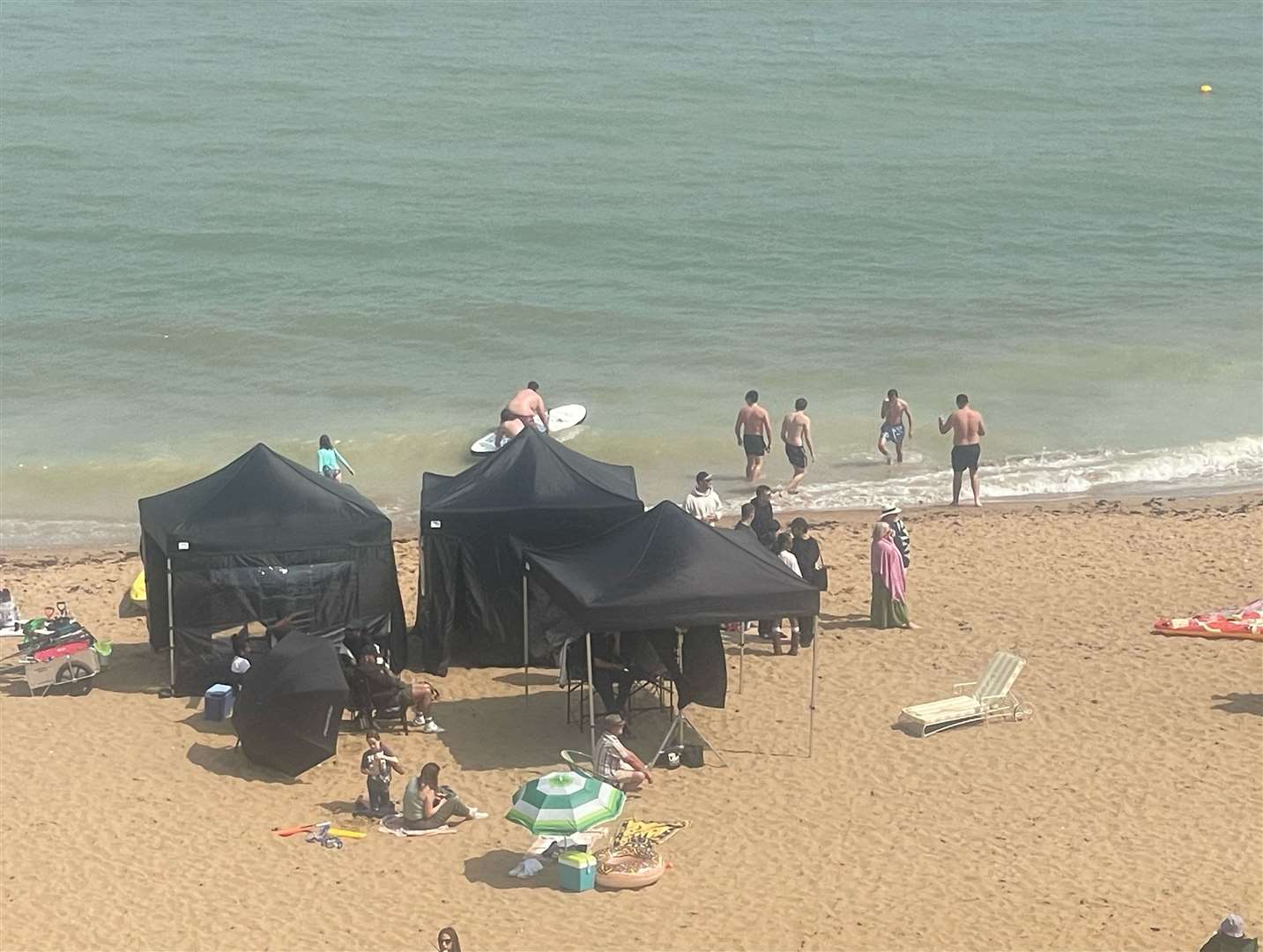 Film crews set up on the sand