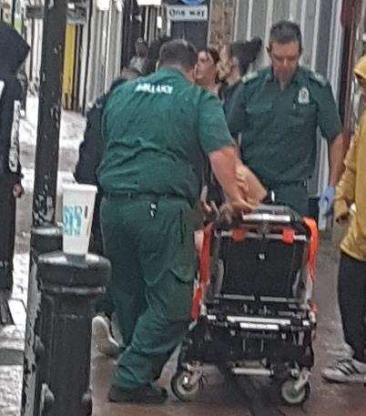 The ambulance crews taking the patient in the stretcher in Ashford town centre (3901823)